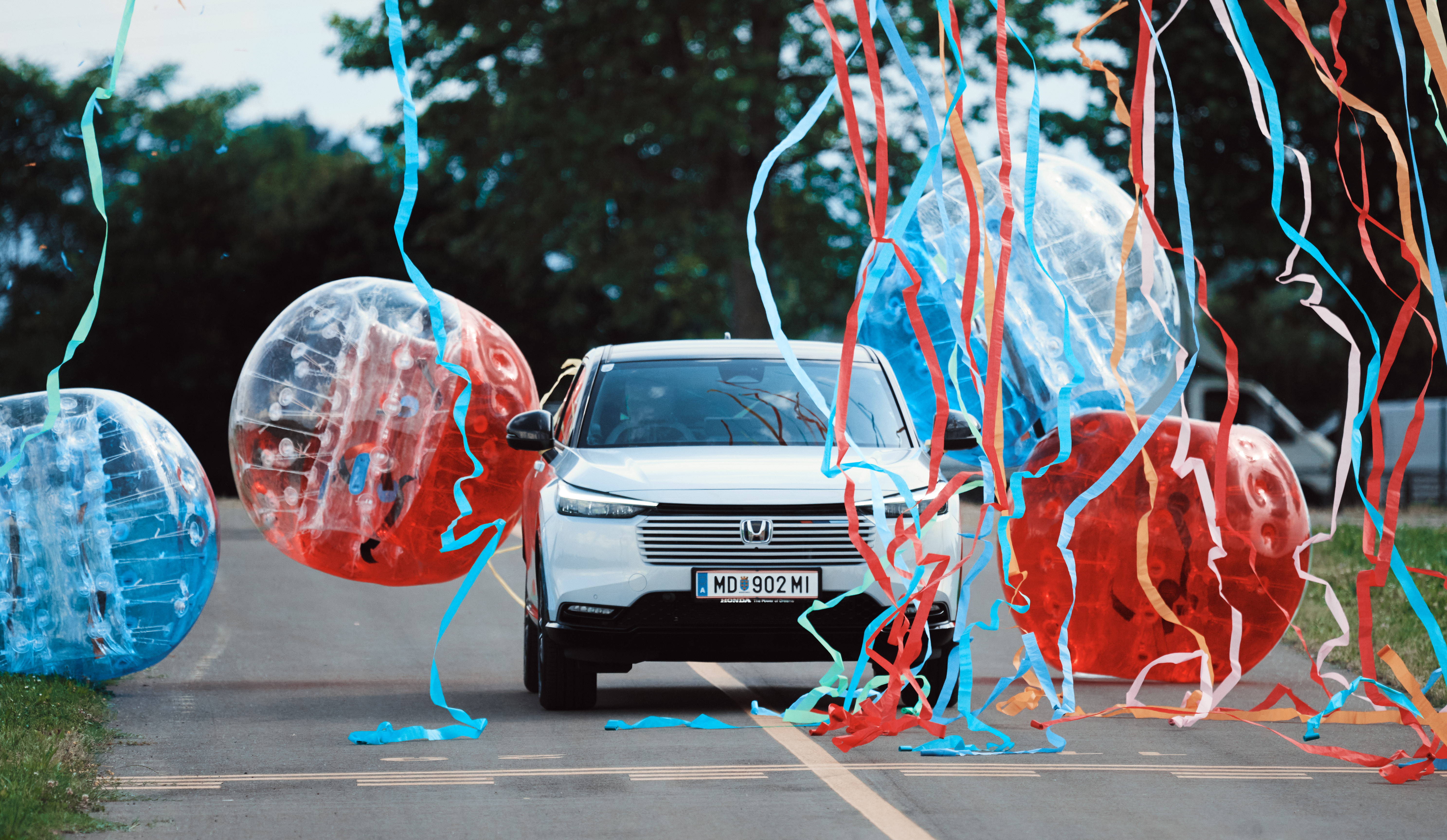 HR-V bumping through a set of balloons
