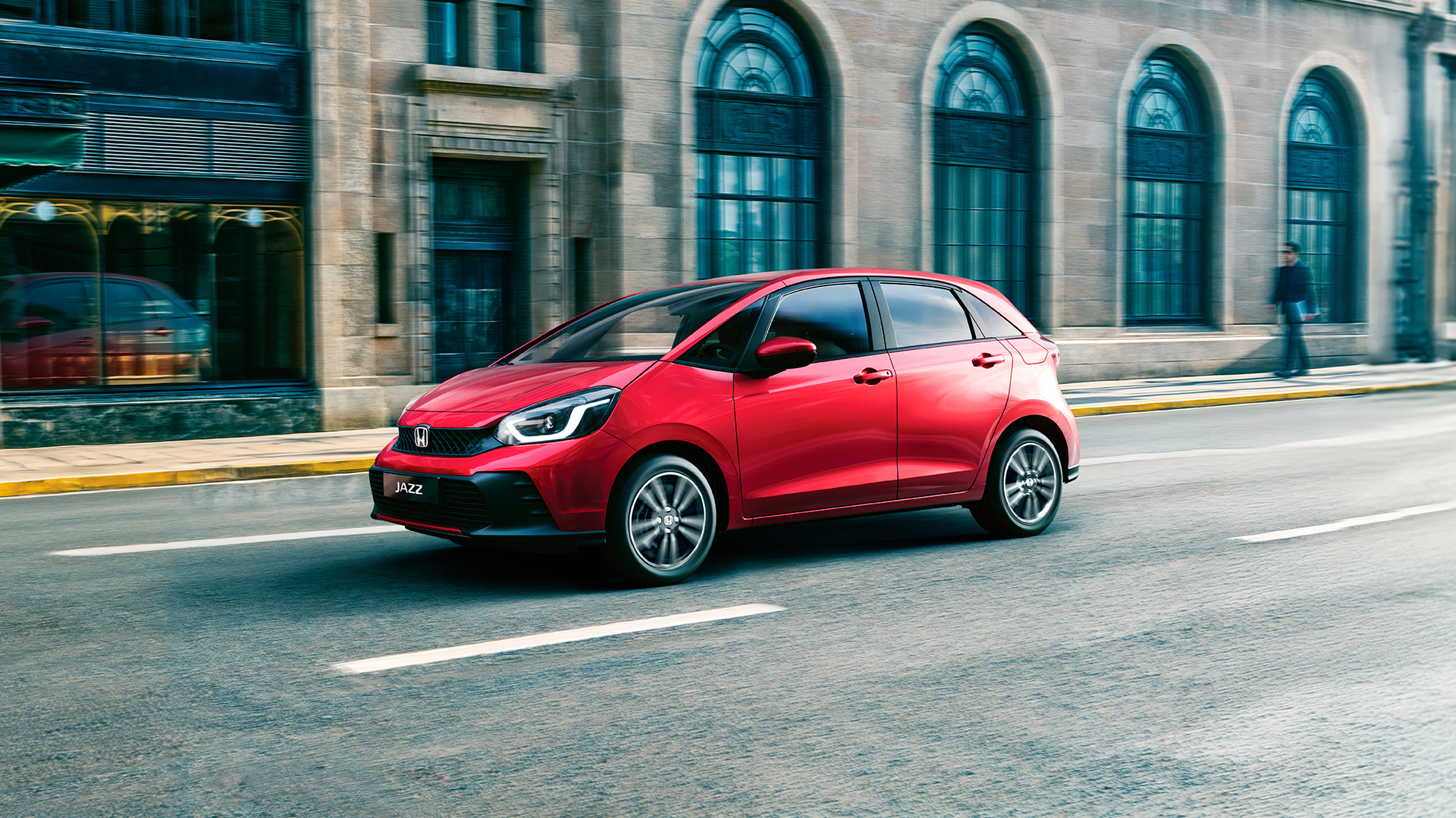 Front Facing 3/4 Honda Jazz driving in a city.