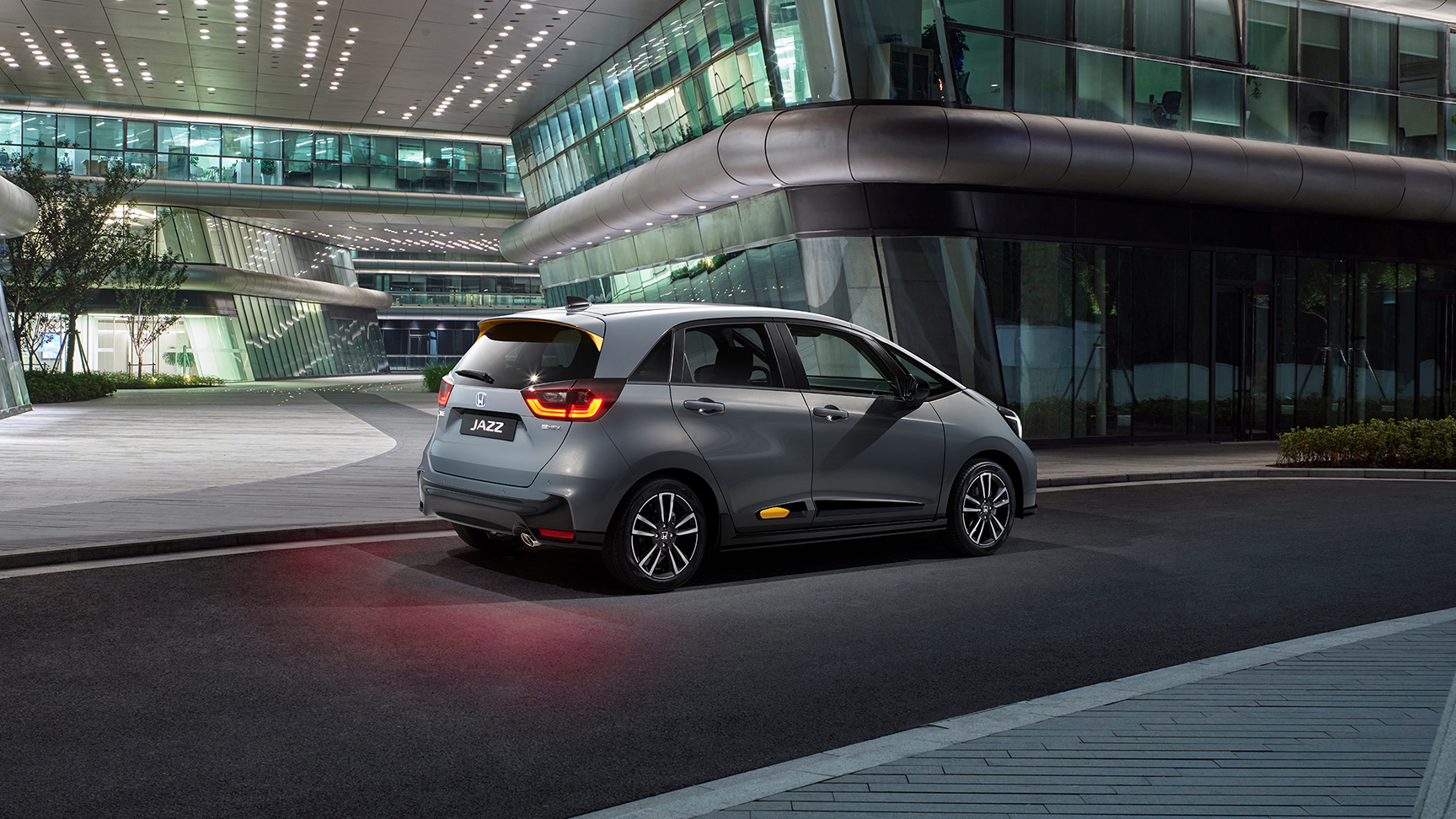 Rear facing Honda Jazz parked in a city location.