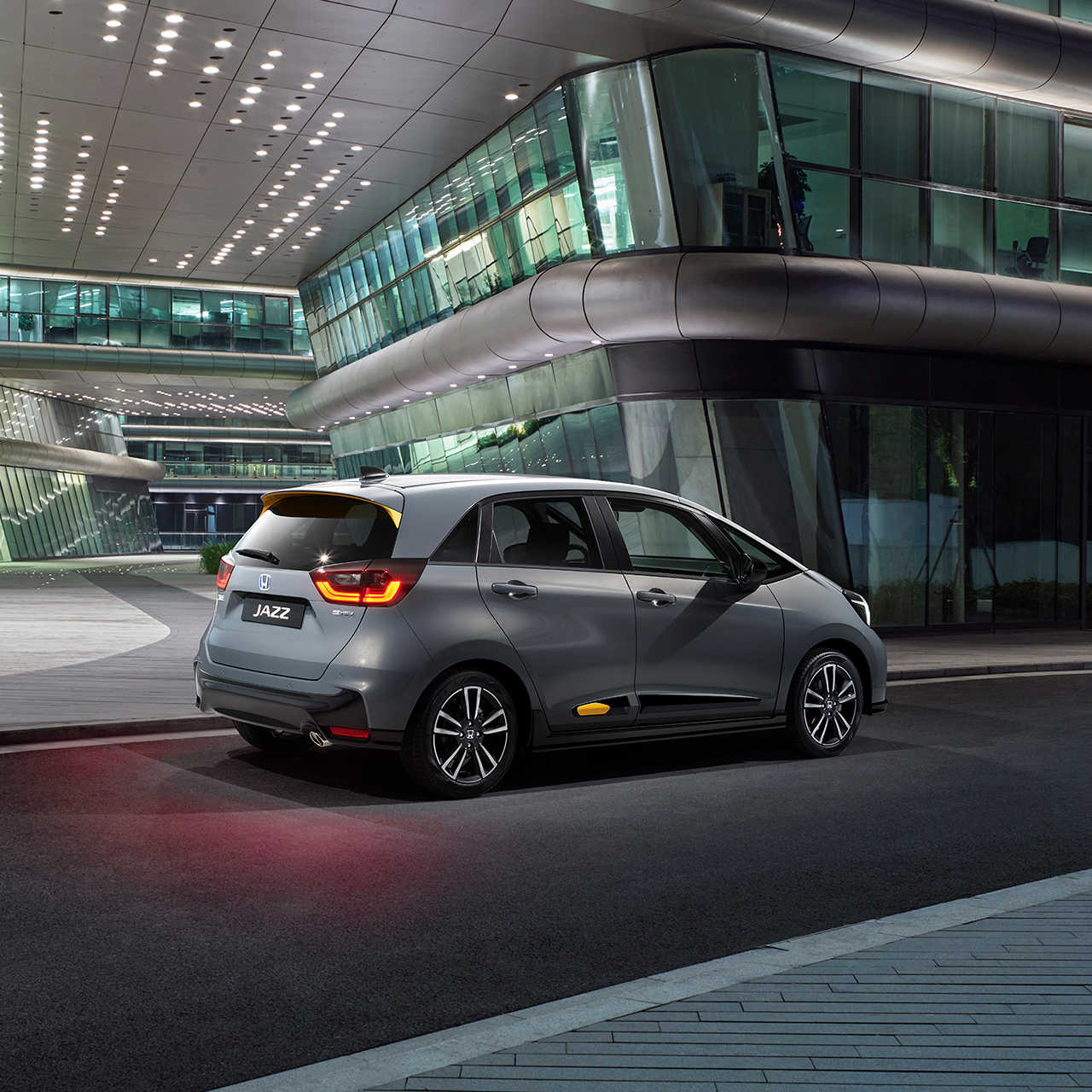 Rear facing Honda Jazz parked in a city location.