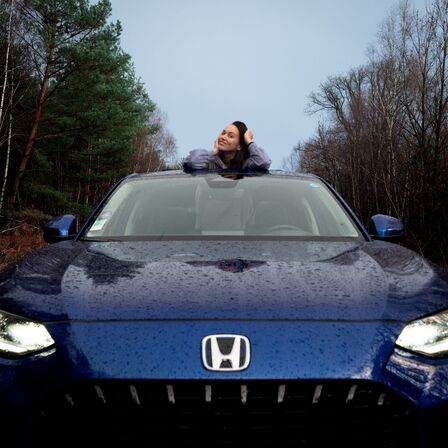 Women standing through sunroof in Honda ZR-V.