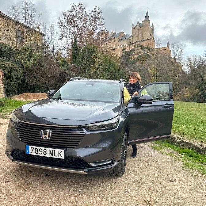 Influencer getting into Honda HR-V in castle location. 