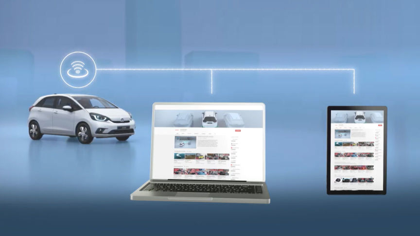 Front facing three quarter Honda Jazz Hybrid next to a laptop and tablet showing wifi connection