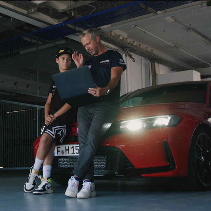 Tiago and Noah sitting on Honda type R with Honda's LogR app