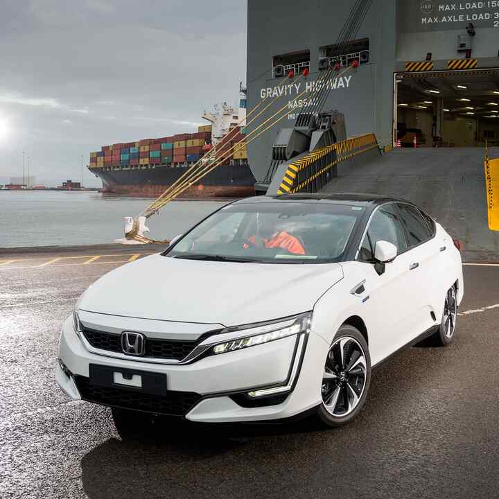 Front three-quarter facing Honda Clarity FCV coming off a boat.