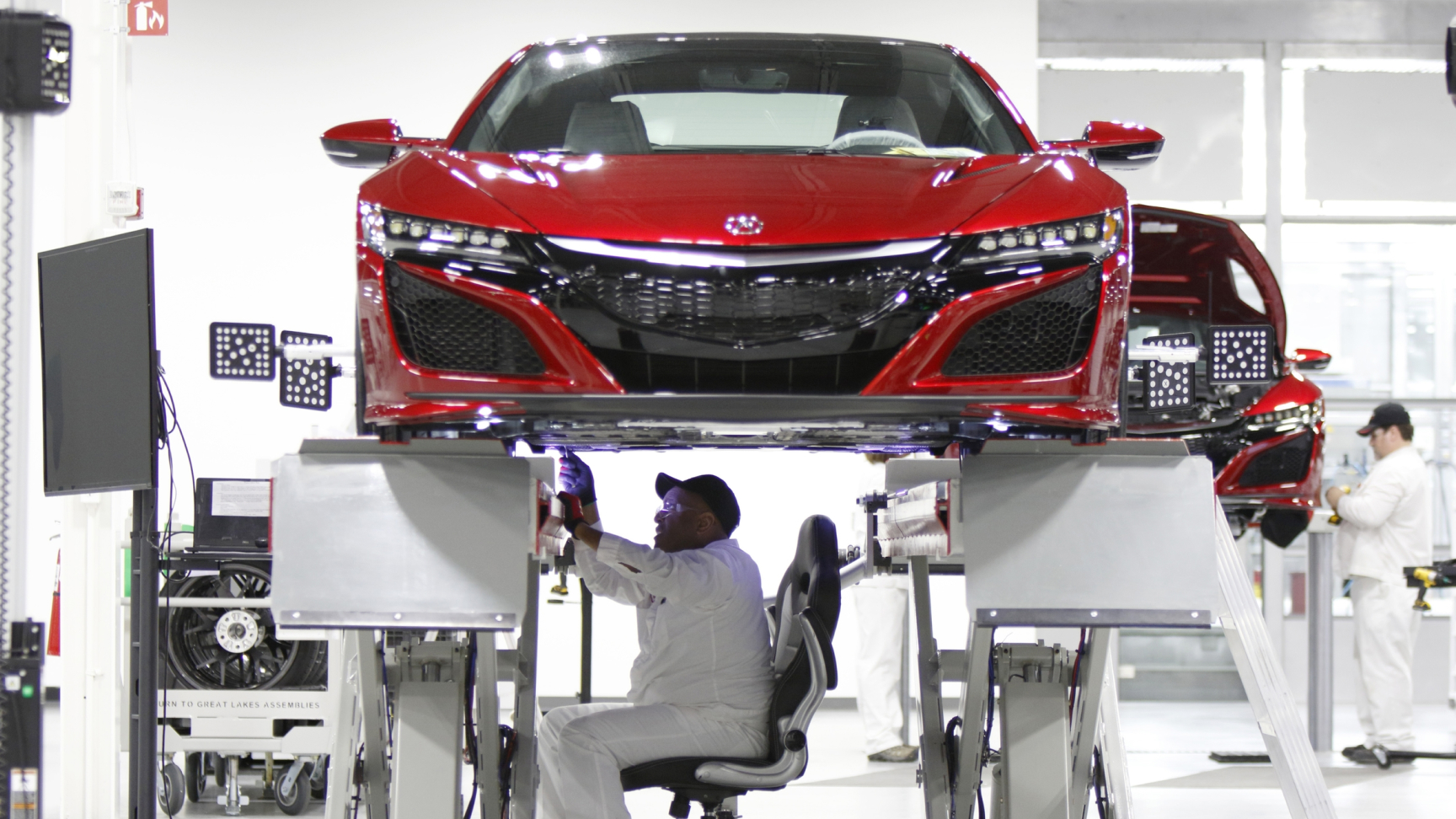 Front facing NSX being worked on by a Honda technician.