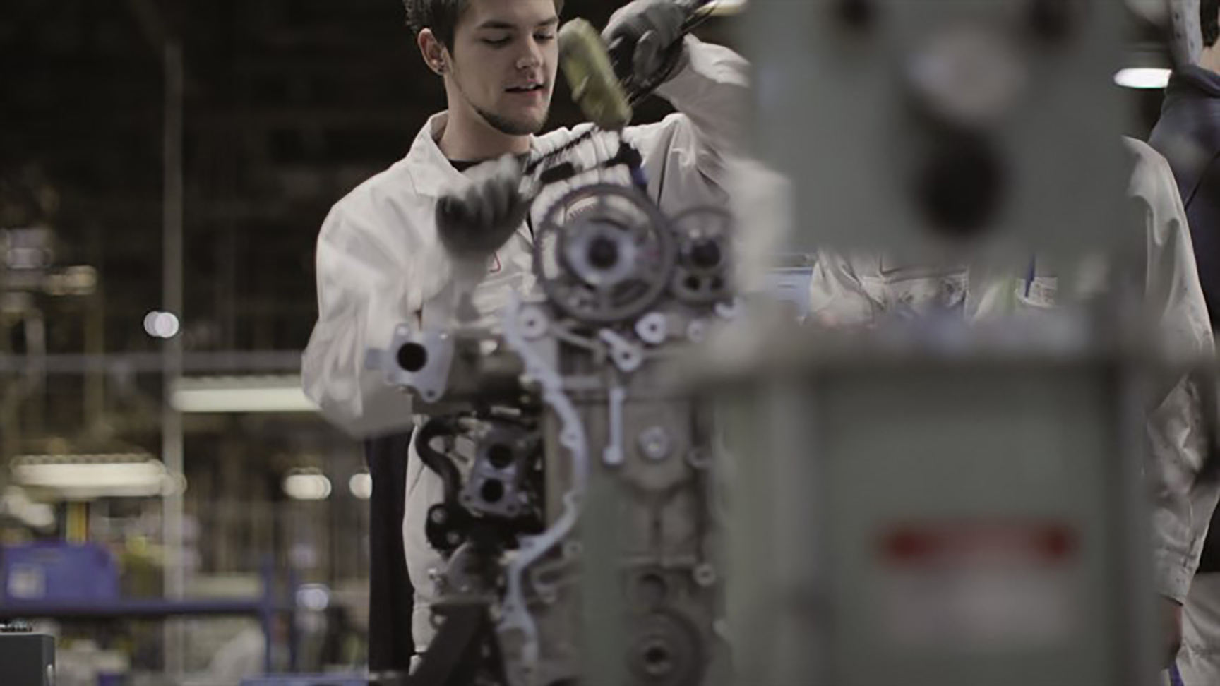 Honda technician working on an engine.
