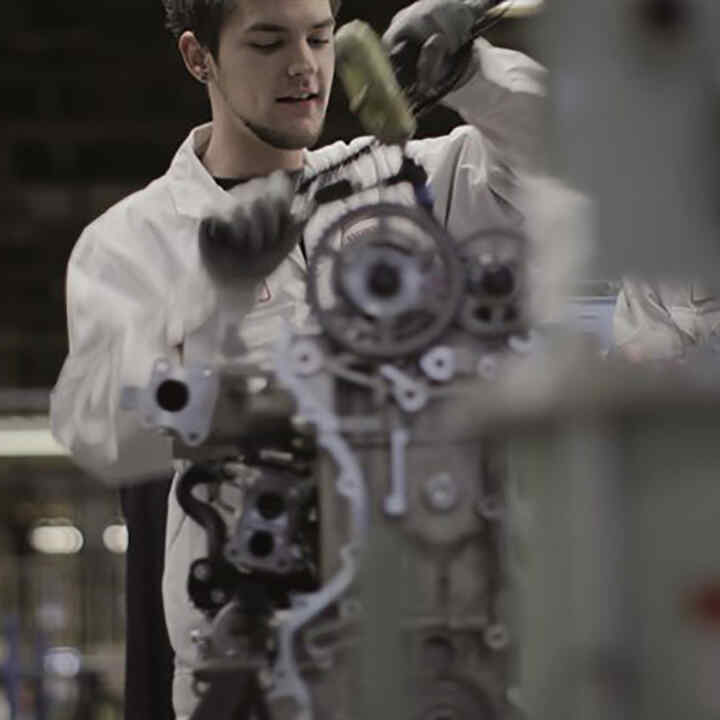 Honda technician working on an engine.