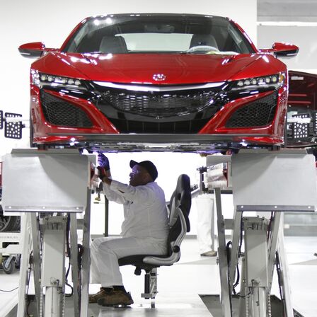 Front facing NSX being worked on by a Honda technician.
