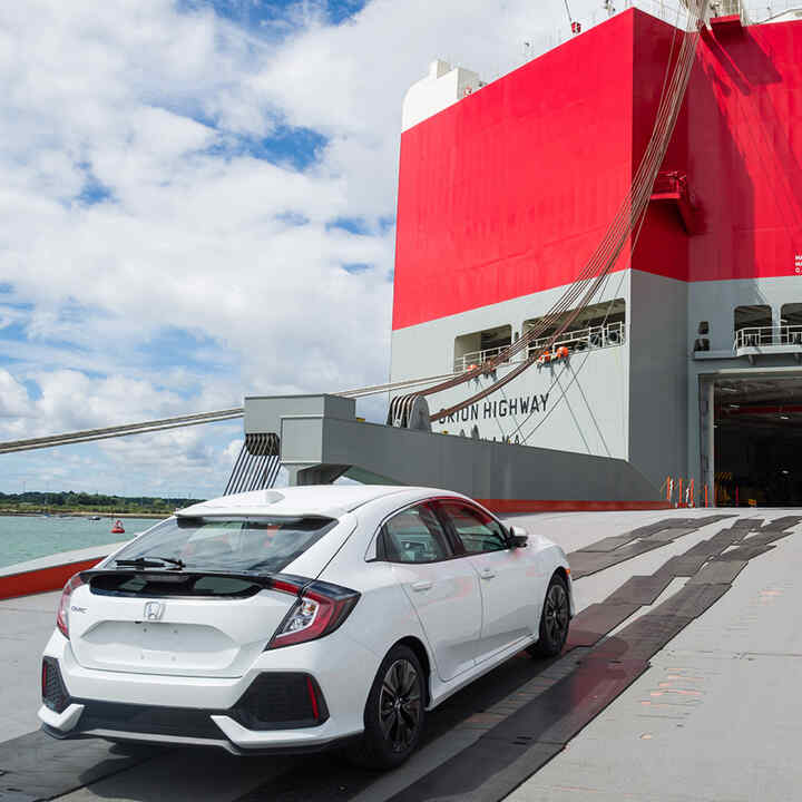 Rear three-quarter facing Honda Civic 5 door being transported to America.