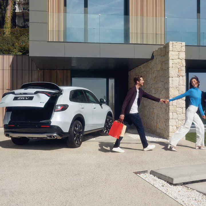 White ZR-V in driveway with power tailgate