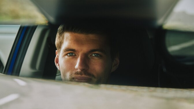 Max Verstappen looking into interior mirror of the ZR-V Hybrid SUV car.