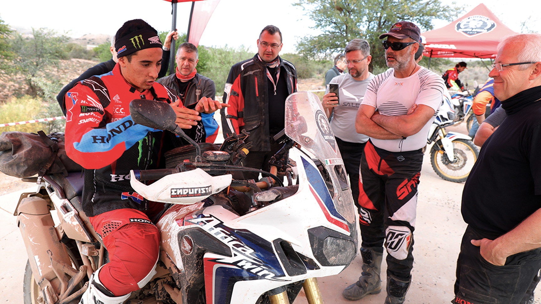HRC rider on Africa Twin giving a briefing session