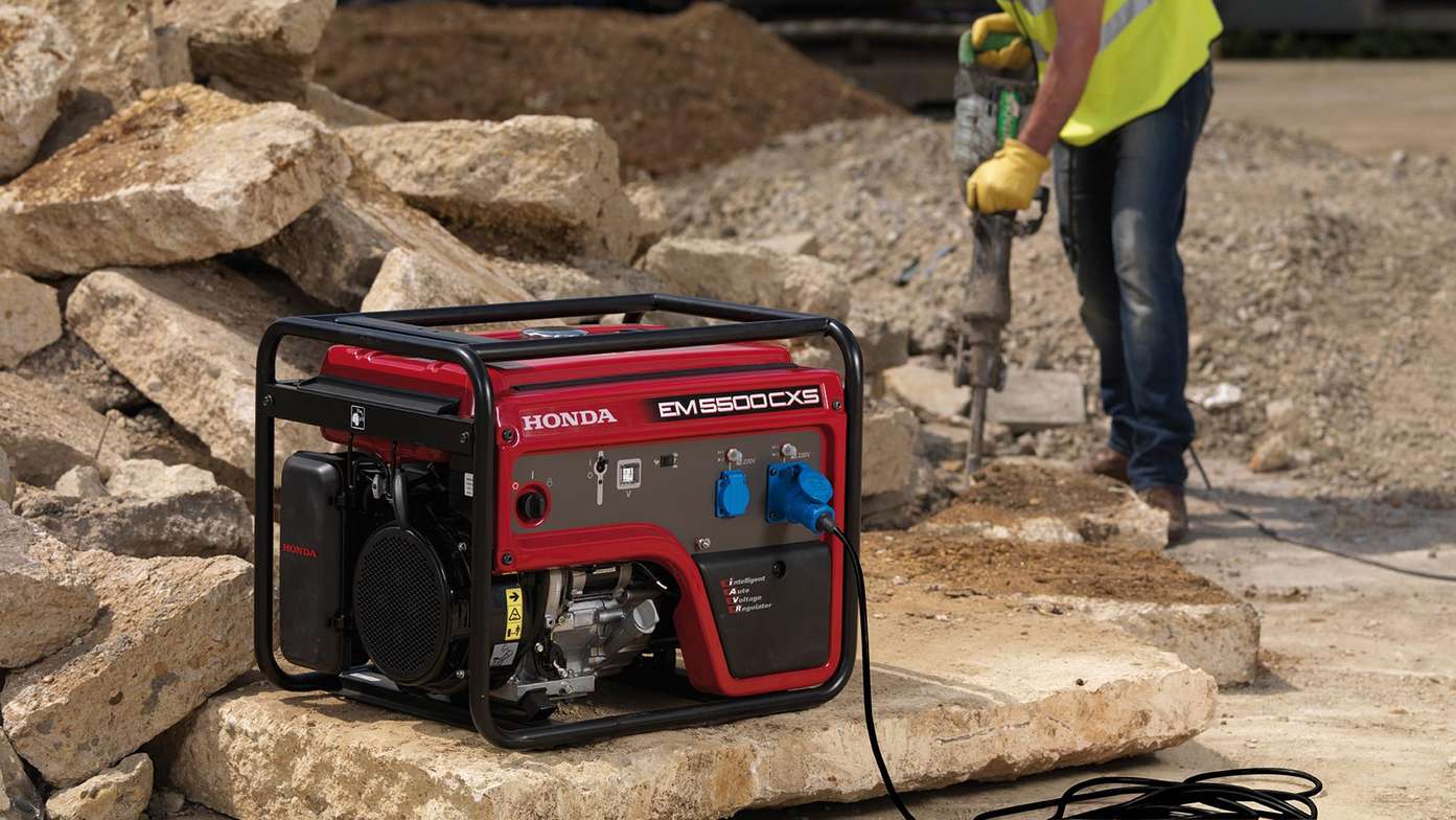 honda red petrol-fuelled power generator on a construction site showing large fuel tank for extended run-time.