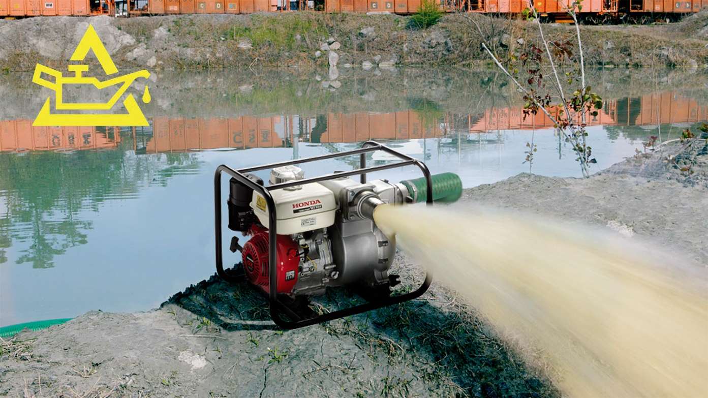 Dirty water trash pump in use in lake setting