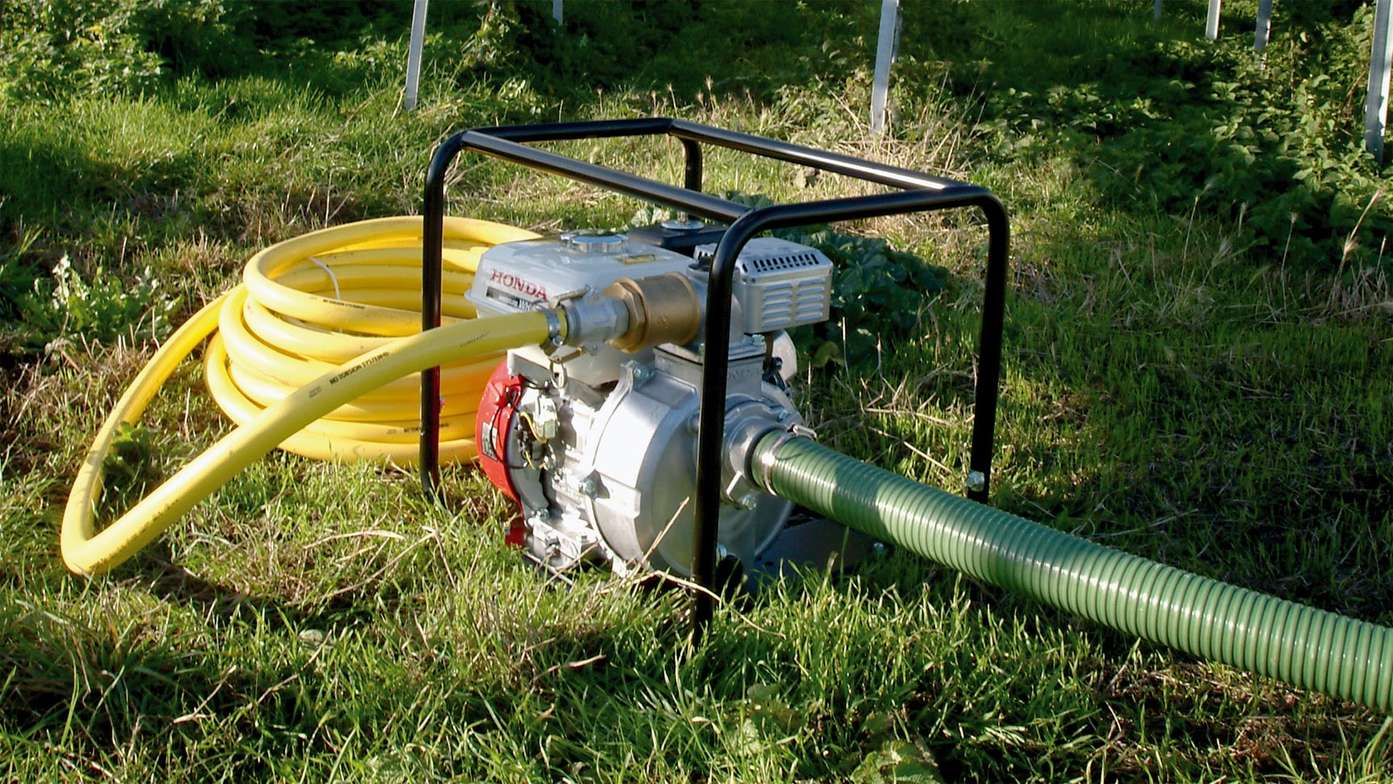 Front view of framed high pressure water pump and Honda HX Series engine.