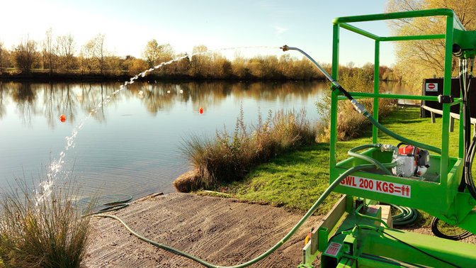 Honda lightweight water pump in use on lake location.