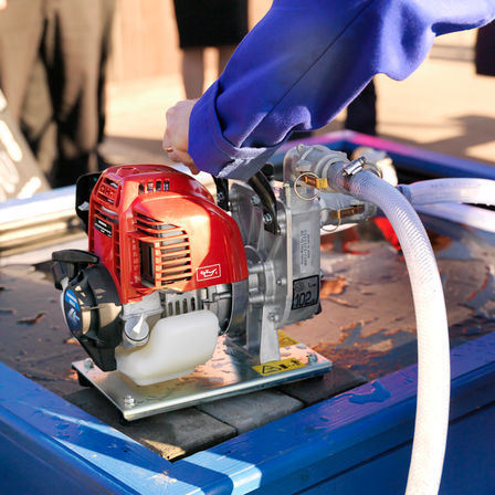 Close up of lightweight water pump, being used by model.