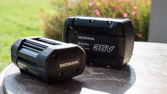 Close up Honda cordless batteries in garden location.