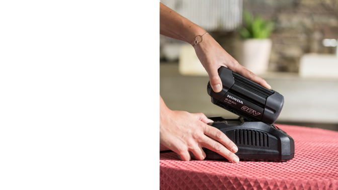 side view of battery and charger for honda cordless gardening product range
