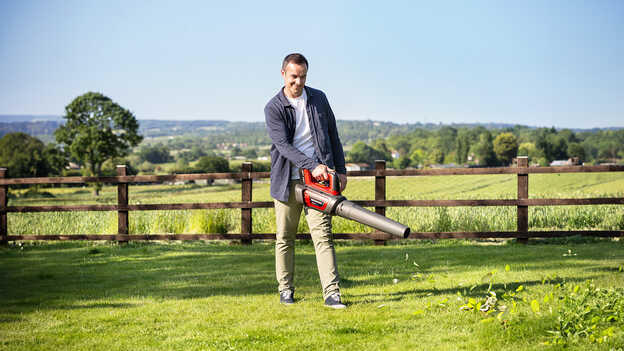 Man in open field using a Cordless Leafblower 