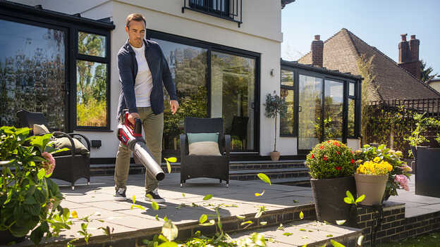 Man using a Cordless Leafblower on patio