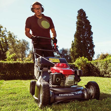 photo of man mowing lawn with honda hrh 536 petrol lawnmower