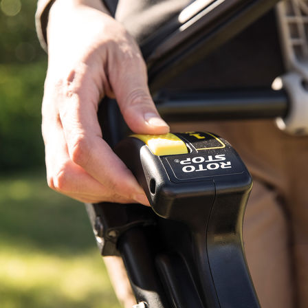 close up of person operating roto-stop system control of honda hrx mower
