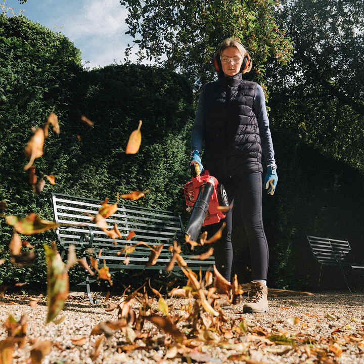 Model using Honda leafblower in city location.