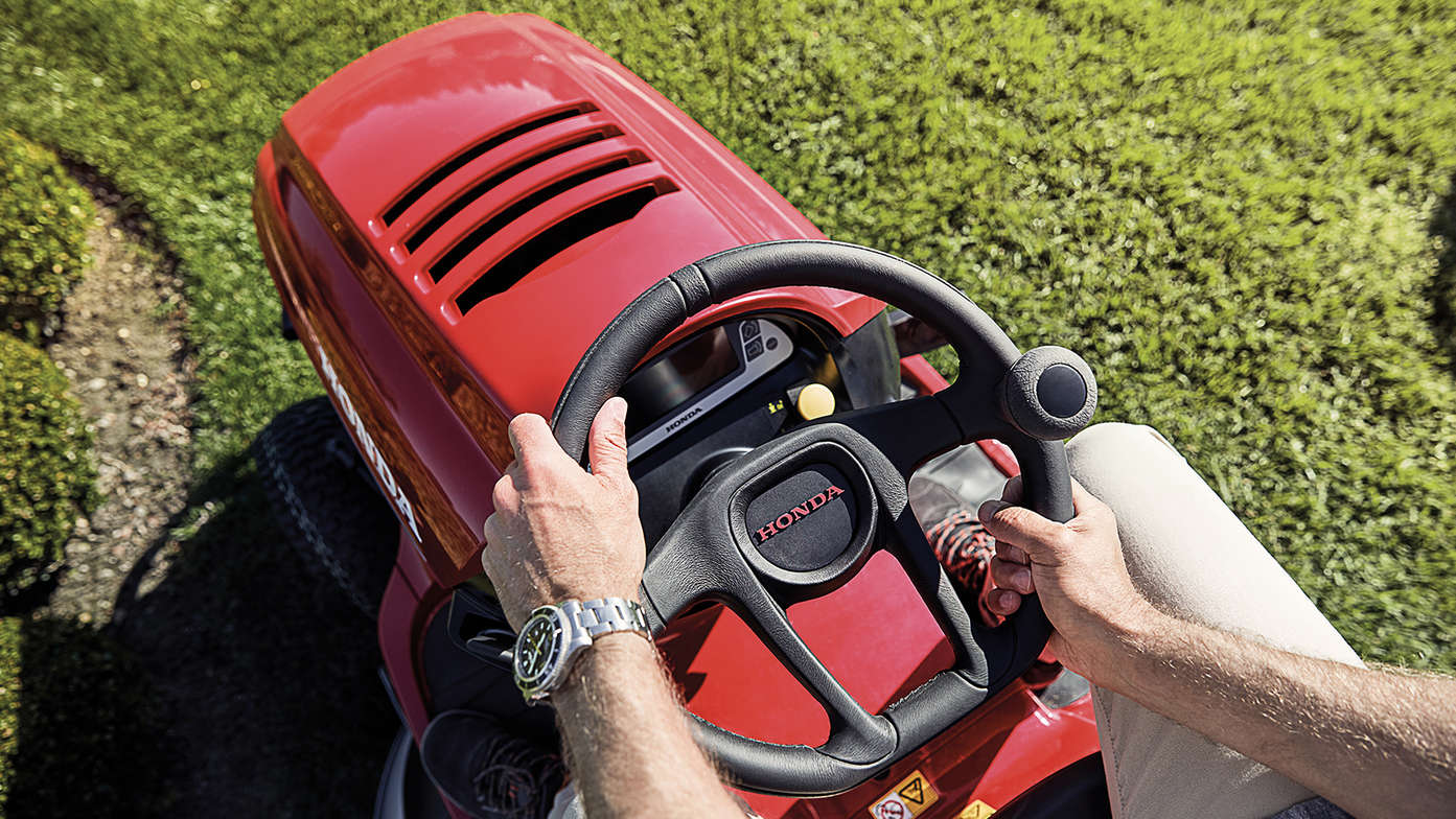 Top view steering wheel and front of tractor with model hands