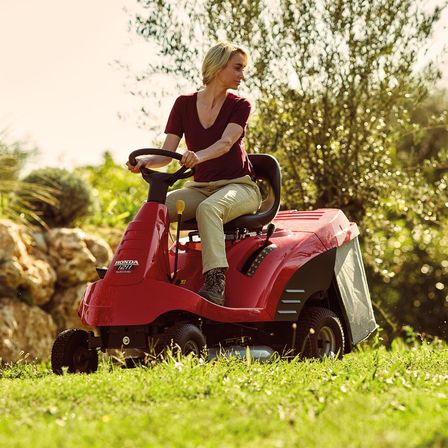 Ride-on, front three-quarter, right facing, being used by model, garden location.