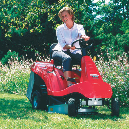Ride-on, front three-quarter, being used by model, garden location.