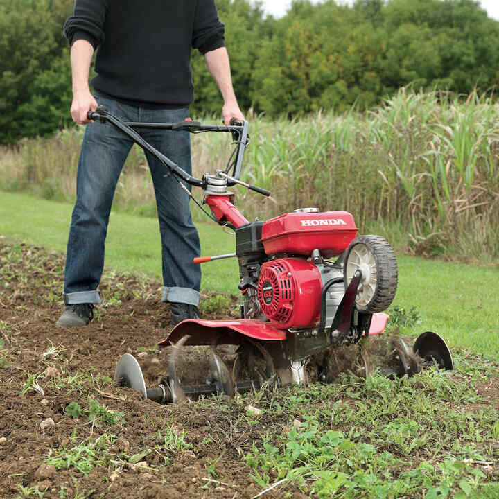 Tiller compact on the soil field.