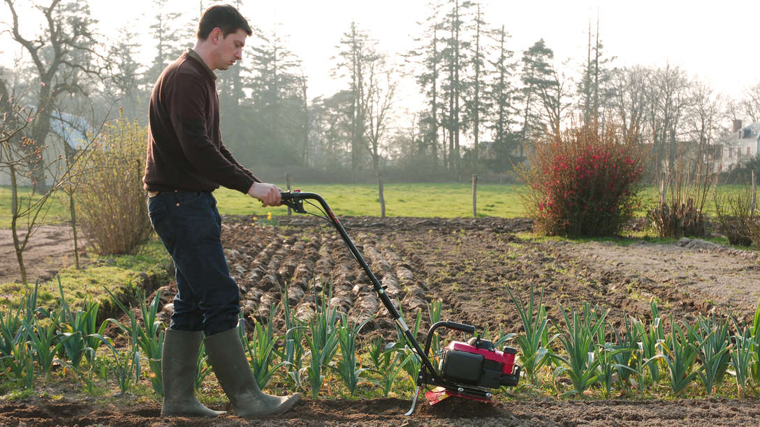 Honda Microtillers, being used by model, on location.