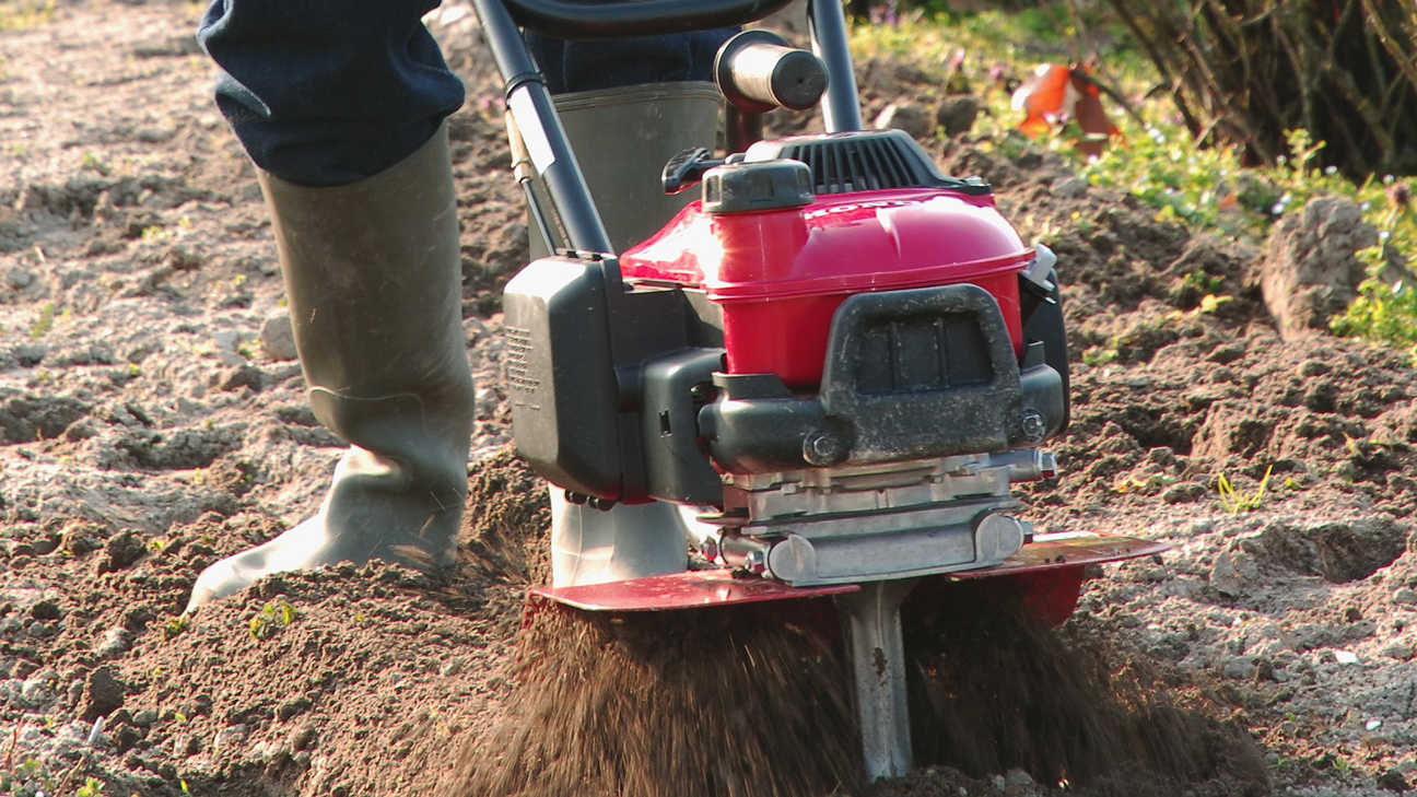 Honda microtillers, in use close up, focusing on blades.