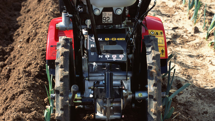 Front facing rotary tiller working on the land.