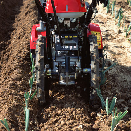 Close up of Rotary tiller, garden location.