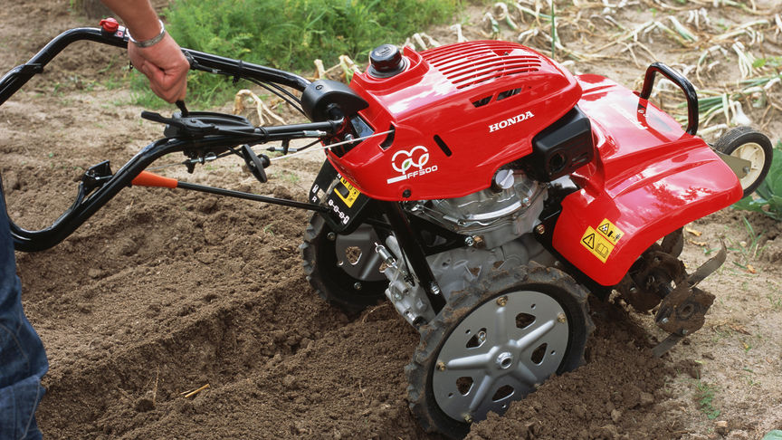 Front facing rotary tiller working on the land.