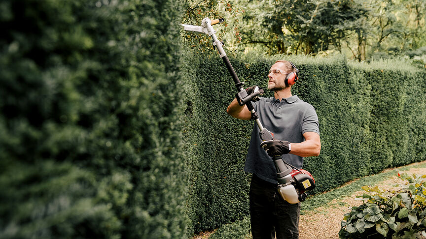 Man using Versatool  with noise cancellation headphones