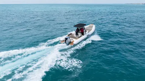 Models in the back of the boat in sea location featuring BF350 engine.