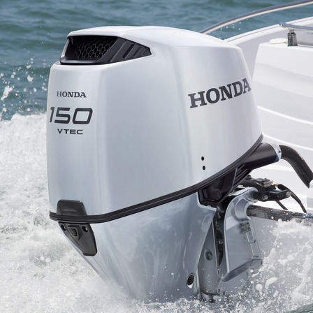 close up of a 150 horsepower honda outboard engine fitted to the boat on the water