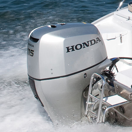 close up of a 115 horsepower honda outboard engine fitted to the boat on the water