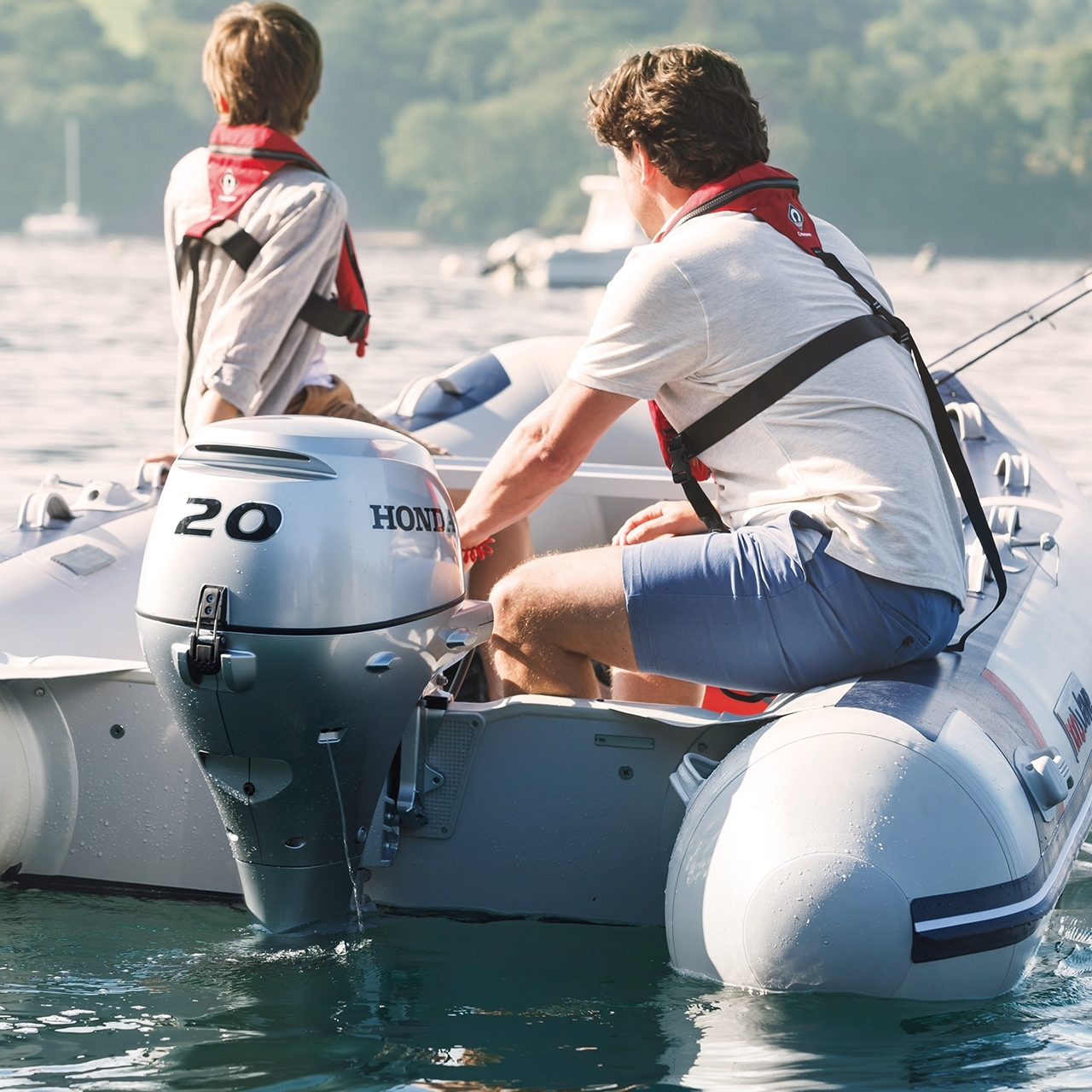 Two males on a Honwave with BF20 engine in lake location.