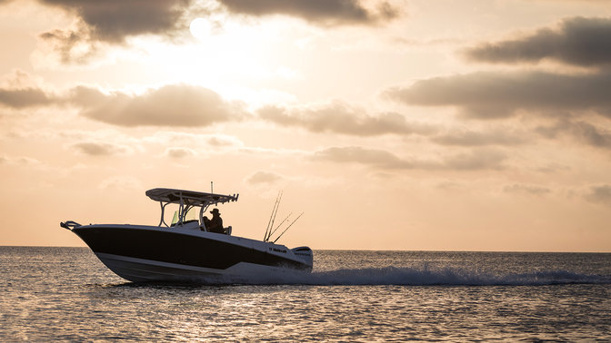 Front three-quarter facing boat with Honda marine engine.