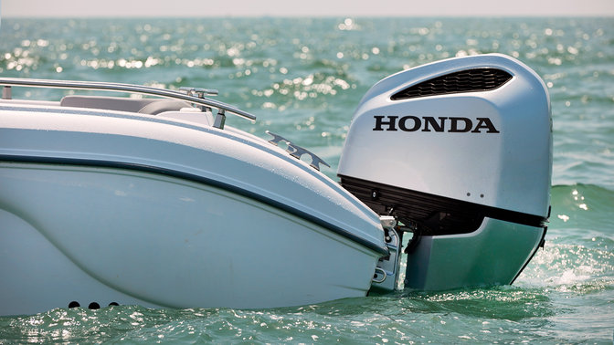 side view of honda marine engine fitted to boat on the water