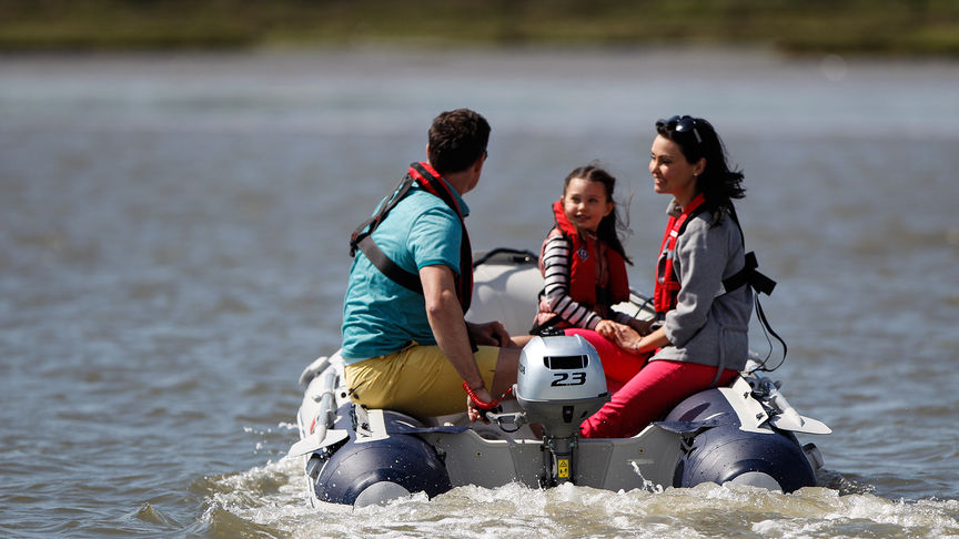 rear view of family on a boat with a honda bf 2.3 outboard engine