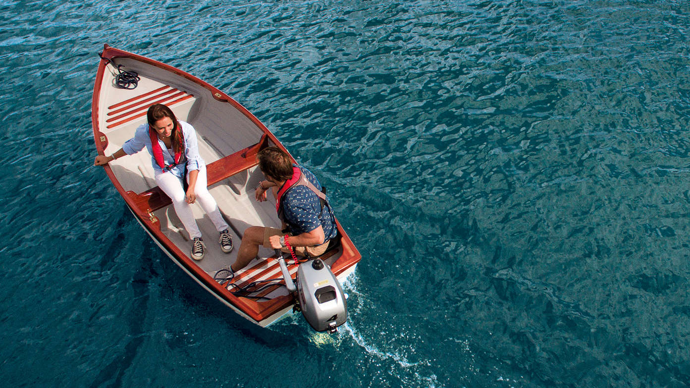 aerial view of couple on a boat with a honda 2-3 horsepower marine engine