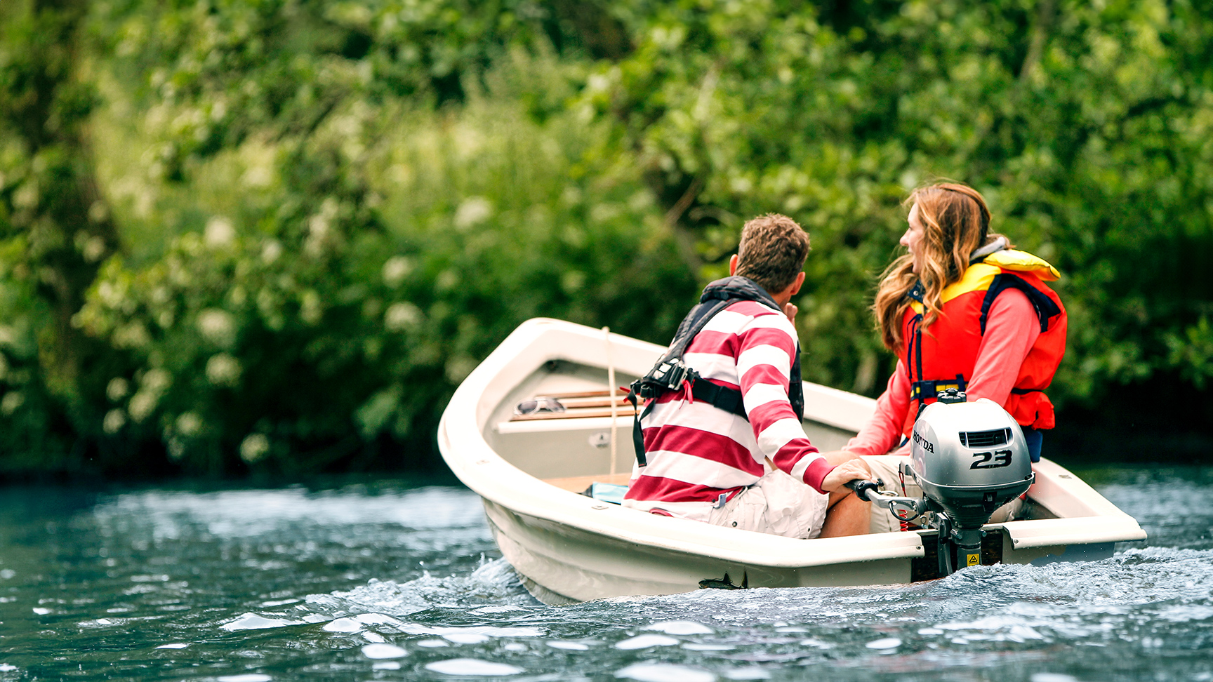 Two people in a boat using the Honda BF2.3 engine.
