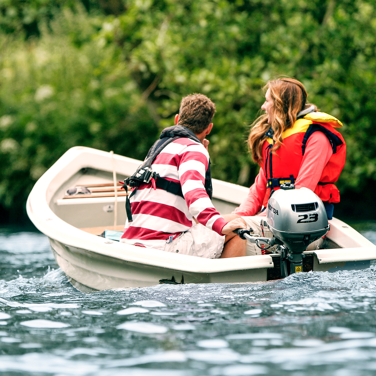 Two people in a boat using the Honda BF2.3 engine.
