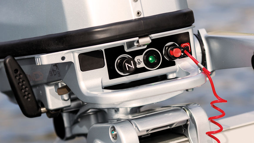 close up of honda outboard engine oil alert system